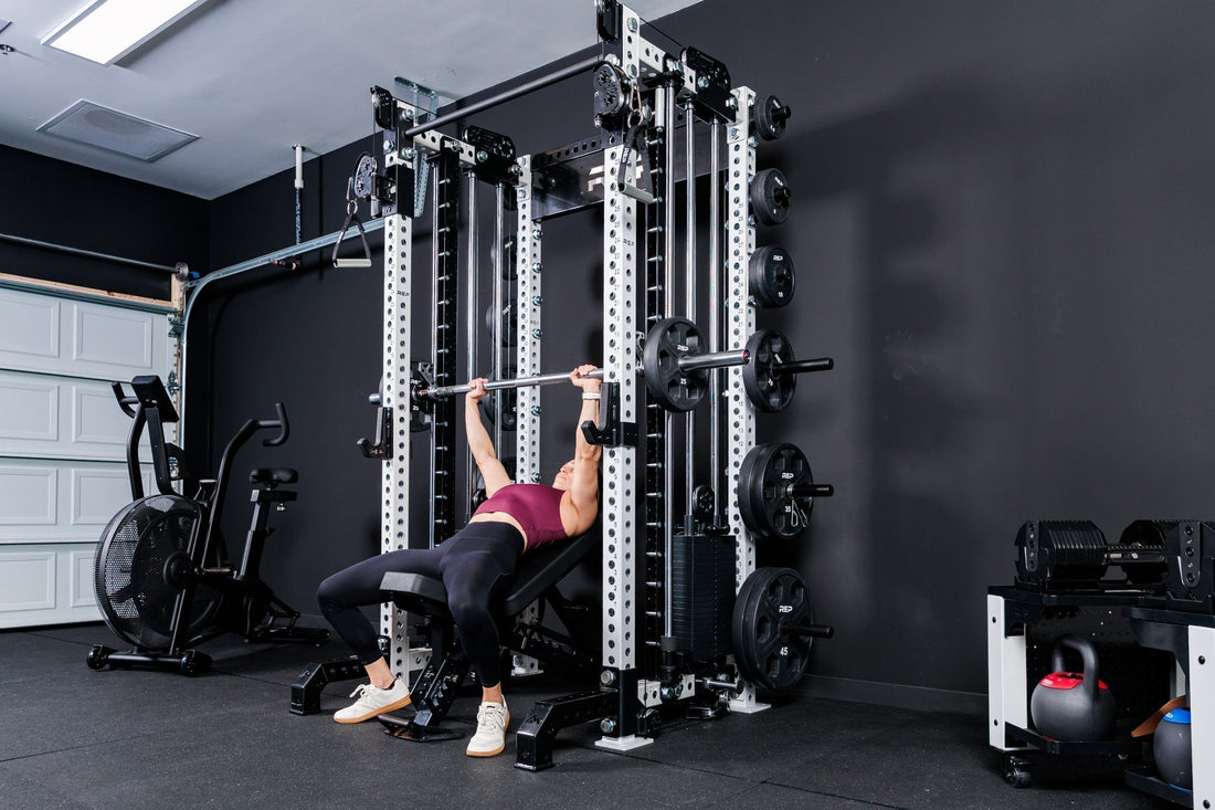 Athlete lifts with REP equipment in a garage gym.