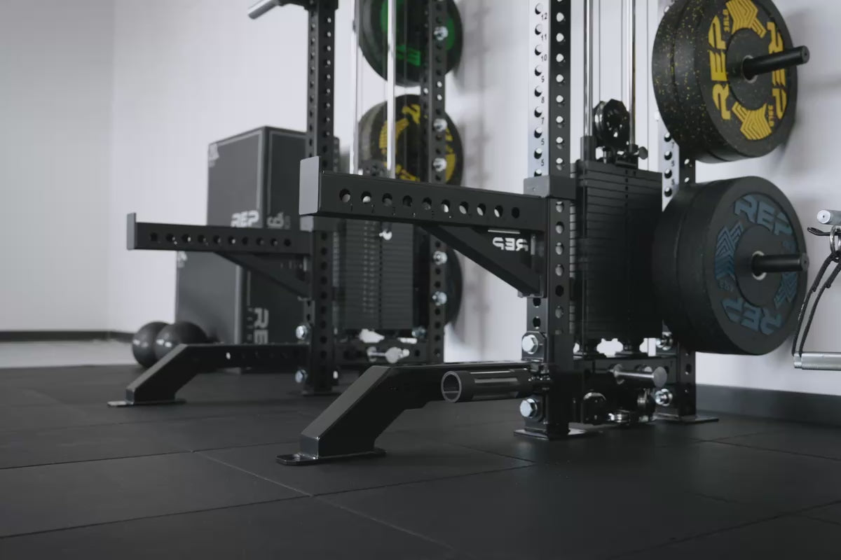 Video of Metallic Black Front Foot Extension Pair 2.0 with REP branding providing stability for a rack with spotter arms in use
