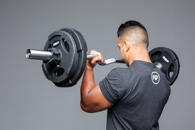 Lifter using loaded curl bar for bicep curls.